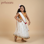 Young girl in traditional outfit with 'pehnara' branding on a beige background