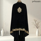 Black velvet abaya with gold embroidery on a hanger against a plain background, featuring the brand 'pehnara'.