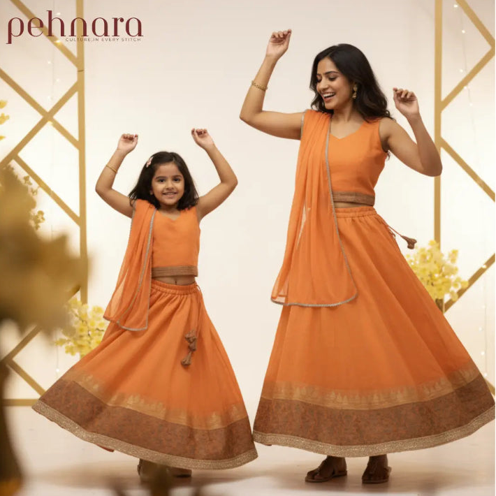 Two women in matching orange traditional outfits with 'pehnara' branding.
