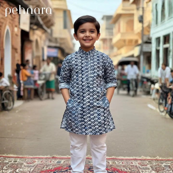 Child wearing a patterned kurta standing on a street with 'pehnara' branding.