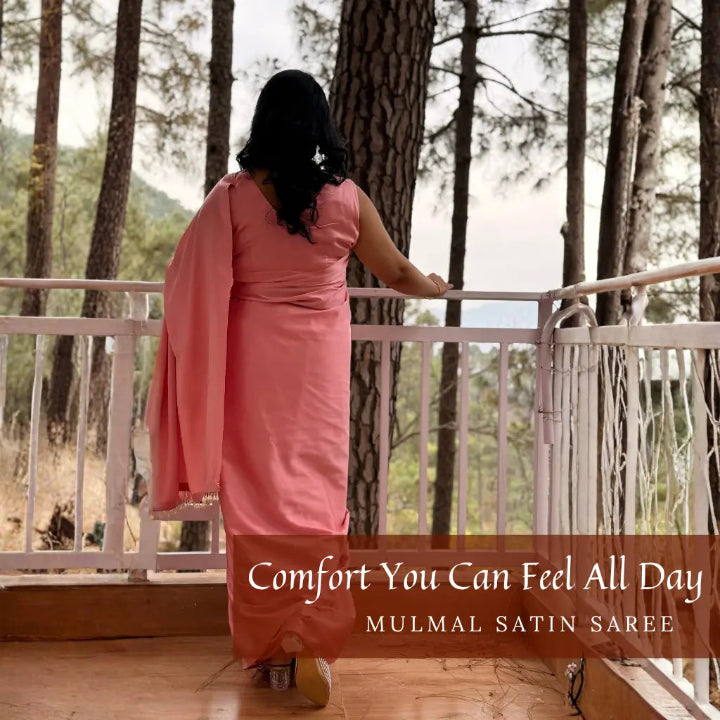 Woman in a pink saree standing on a wooden deck with trees in the background