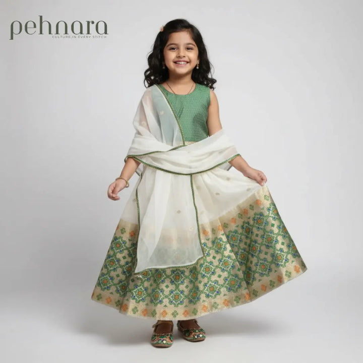 Young girl wearing a green and white traditional outfit with 'pehnara' branding.