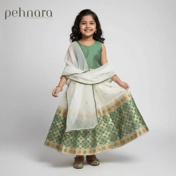 Young girl wearing a green and white traditional outfit with 'pehnara' branding.